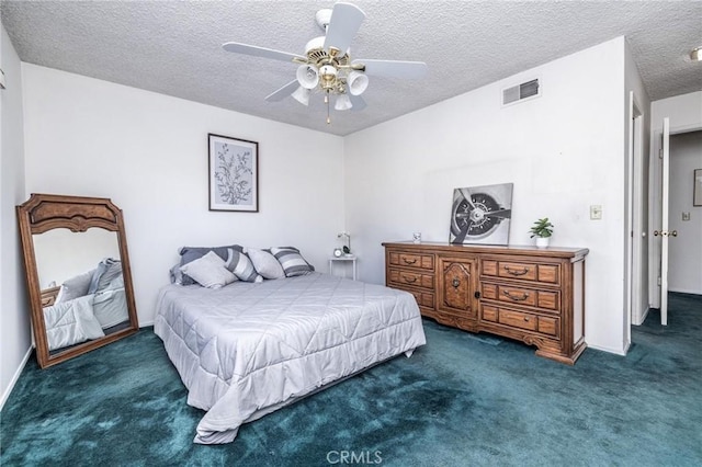 bedroom with dark colored carpet, a textured ceiling, and ceiling fan