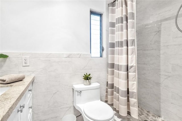 bathroom featuring curtained shower, tile walls, and toilet