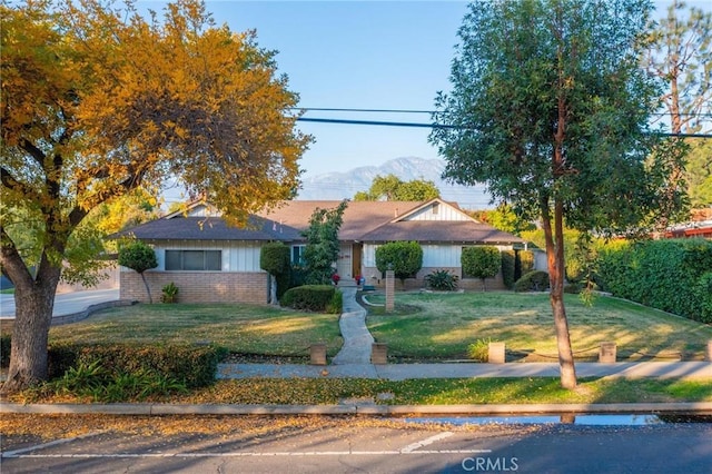 view of front facade with a mountain view and a front lawn