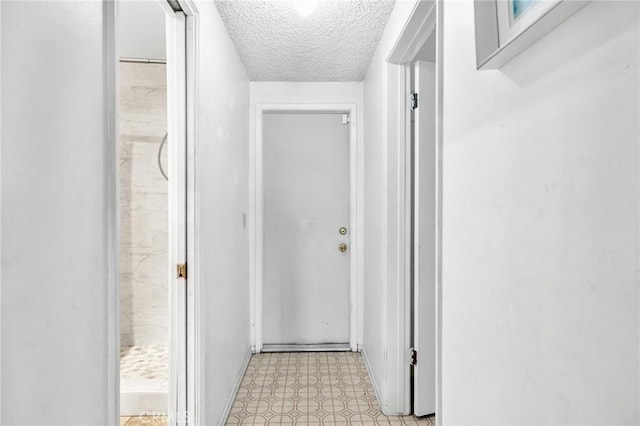 hallway with a textured ceiling