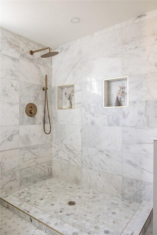 bathroom with a tile shower