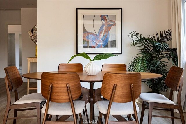 dining space featuring wood-type flooring