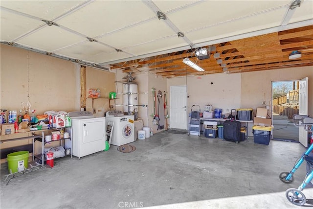 garage with washing machine and dryer and a garage door opener