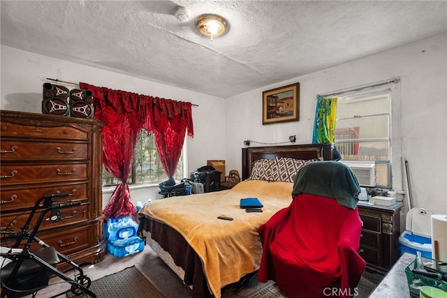 bedroom with cooling unit and a textured ceiling