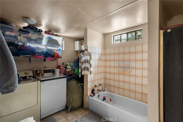 bathroom with washer and dryer, tile patterned floors, and shower / bathtub combination