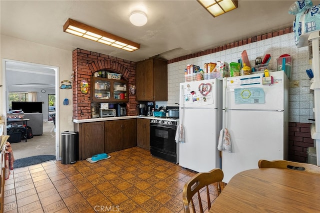 kitchen featuring gas stove and white refrigerator