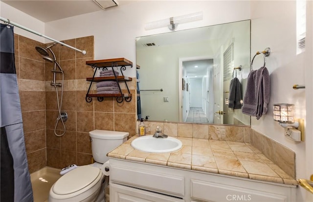 bathroom with curtained shower, vanity, and toilet