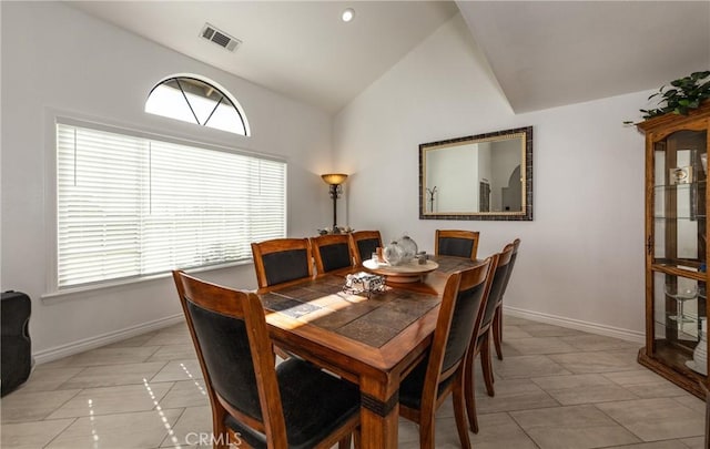 dining room with light tile patterned flooring and lofted ceiling