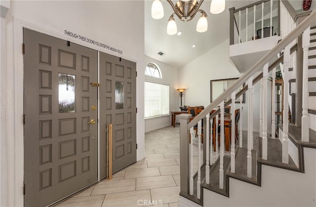 foyer featuring high vaulted ceiling and a chandelier