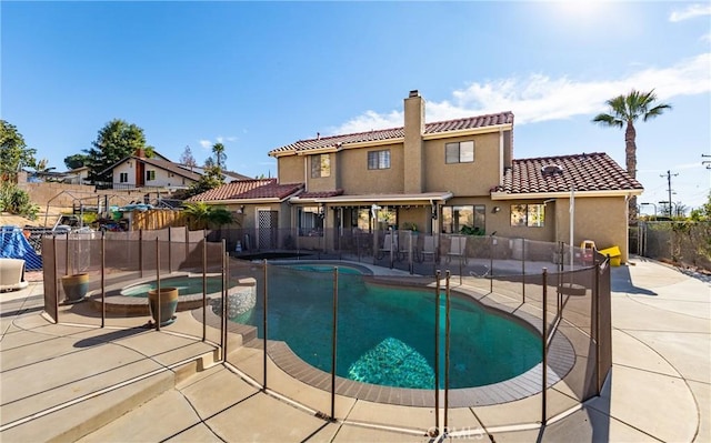 view of pool with a patio area and an in ground hot tub