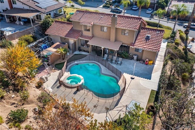 view of swimming pool featuring an in ground hot tub