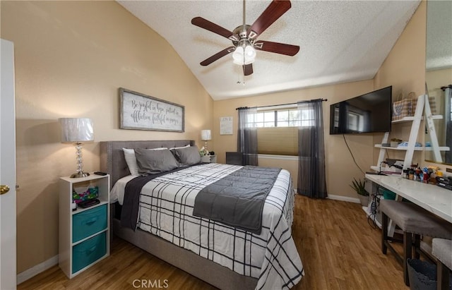 bedroom with hardwood / wood-style floors, ceiling fan, a textured ceiling, and vaulted ceiling