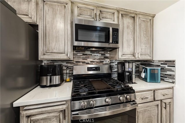 kitchen with decorative backsplash and stainless steel appliances