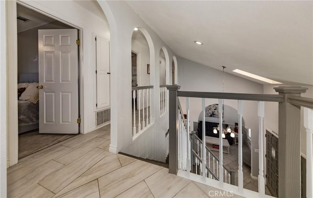 hall with lofted ceiling with skylight