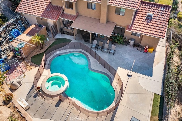 view of pool featuring an in ground hot tub