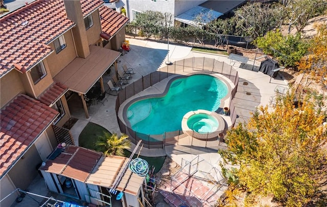 view of pool with an in ground hot tub