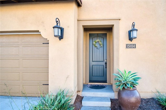 view of exterior entry featuring a garage