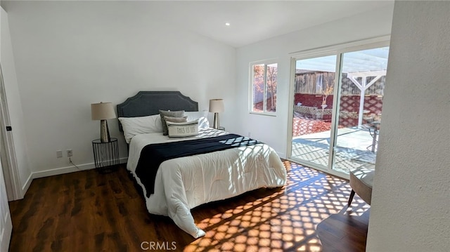 bedroom with access to outside and dark hardwood / wood-style floors