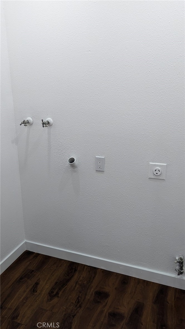 laundry room with hookup for a gas dryer and dark hardwood / wood-style flooring