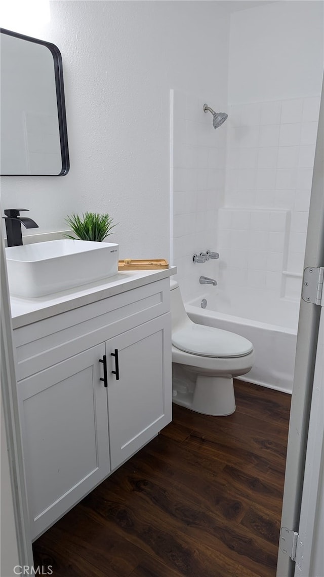 full bathroom featuring bathing tub / shower combination, vanity, wood-type flooring, and toilet