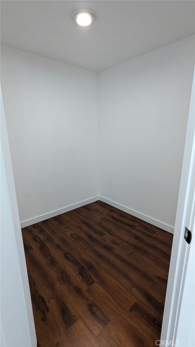 spare room featuring dark wood-type flooring