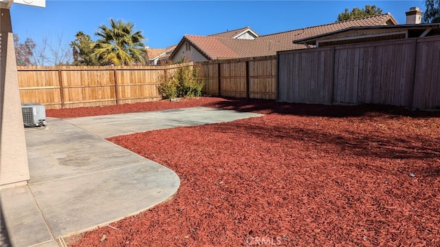 view of yard featuring a patio and central AC