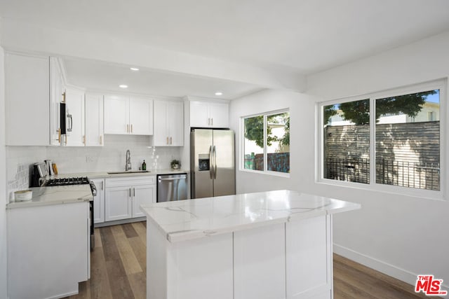 kitchen featuring white cabinets, a center island, dark hardwood / wood-style flooring, and appliances with stainless steel finishes