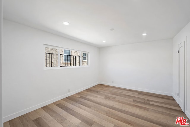 spare room featuring light hardwood / wood-style flooring