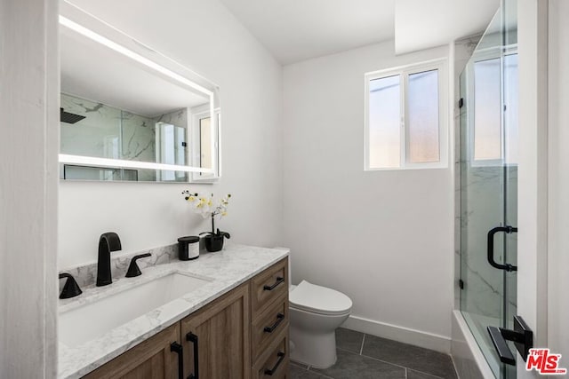 bathroom with tile patterned flooring, vanity, toilet, and an enclosed shower