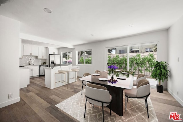 dining room featuring hardwood / wood-style flooring and sink