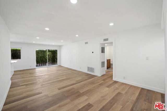 unfurnished living room with light wood-type flooring