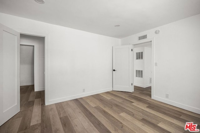 spare room featuring hardwood / wood-style flooring