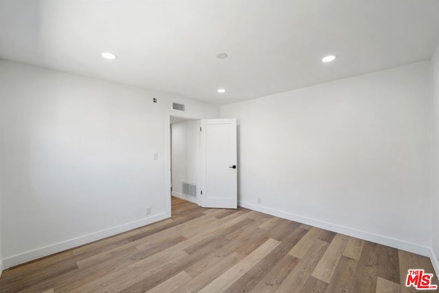 spare room with light wood-type flooring