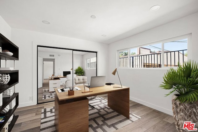 home office with hardwood / wood-style flooring