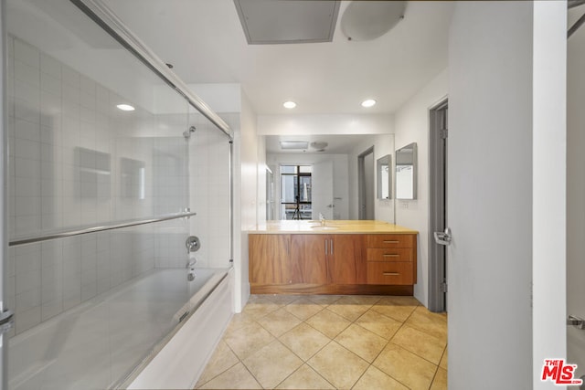 bathroom featuring vanity, tile patterned floors, and shower / bath combination with glass door