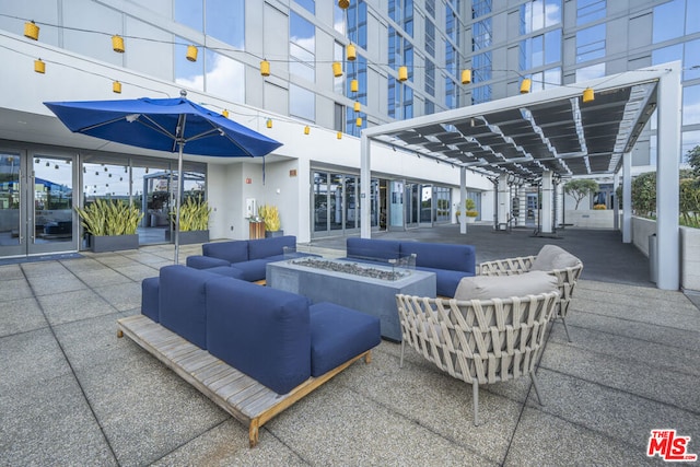 view of patio / terrace featuring an outdoor living space with a fire pit