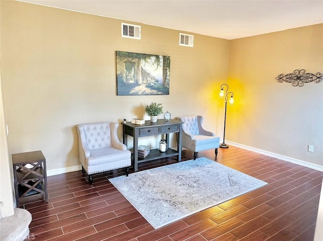 sitting room with dark wood-type flooring