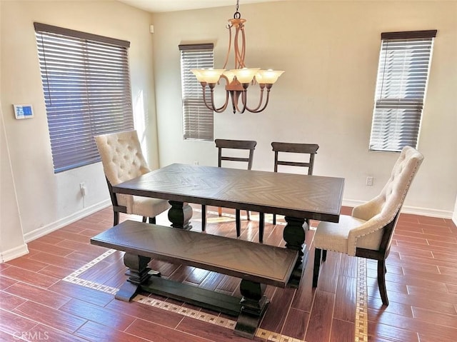 dining room with dark hardwood / wood-style flooring and a chandelier