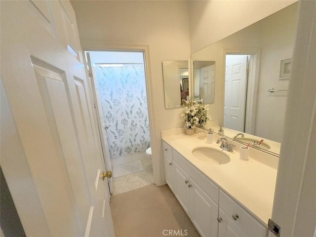 bathroom with curtained shower, tile patterned flooring, vanity, and toilet