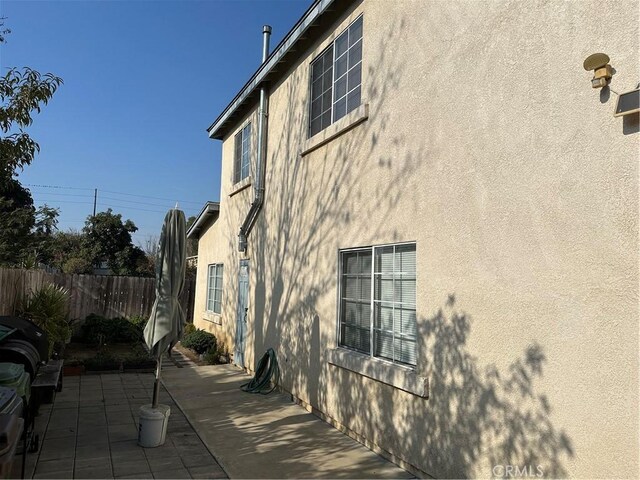 view of property exterior with a patio