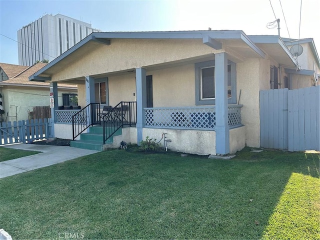 view of front of property with a porch and a front yard