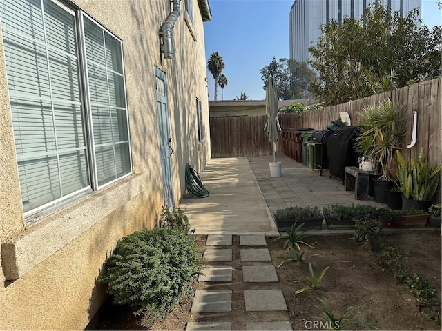 view of side of property with a patio