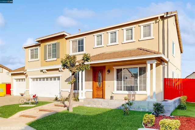 view of front of property with a front yard and a garage