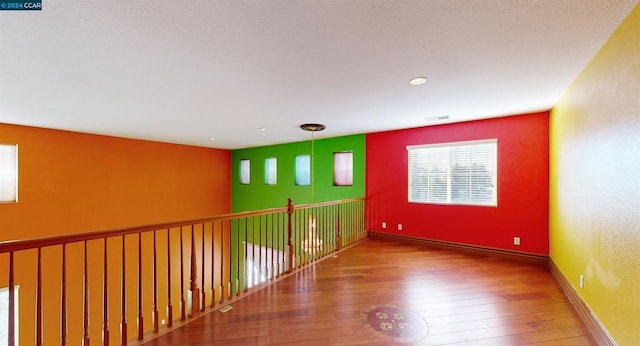 spare room featuring wood-type flooring