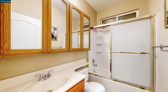 full bathroom featuring toilet, vanity, and combined bath / shower with glass door