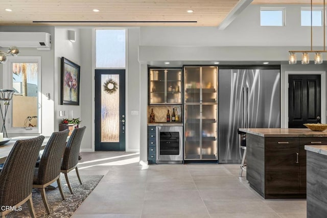 bar featuring pendant lighting, wine cooler, stainless steel fridge, wooden ceiling, and a wall unit AC