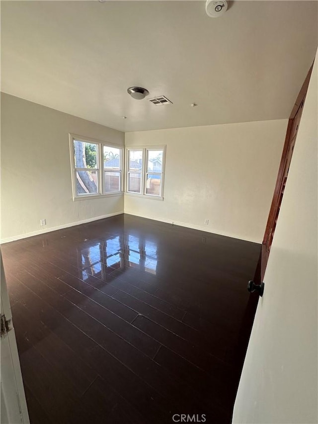 unfurnished room with dark hardwood / wood-style floors