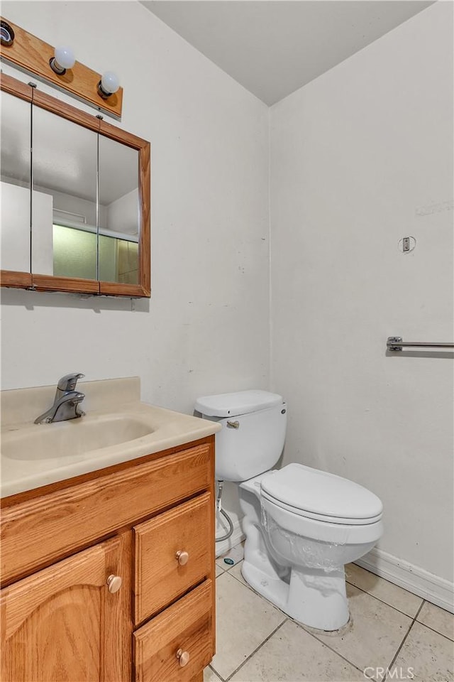 bathroom featuring tile patterned floors, vanity, and toilet