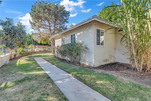 view of home's exterior featuring a yard