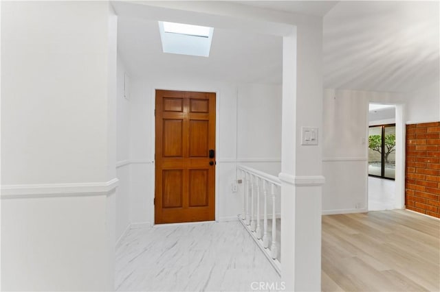 entryway featuring light hardwood / wood-style flooring and a skylight